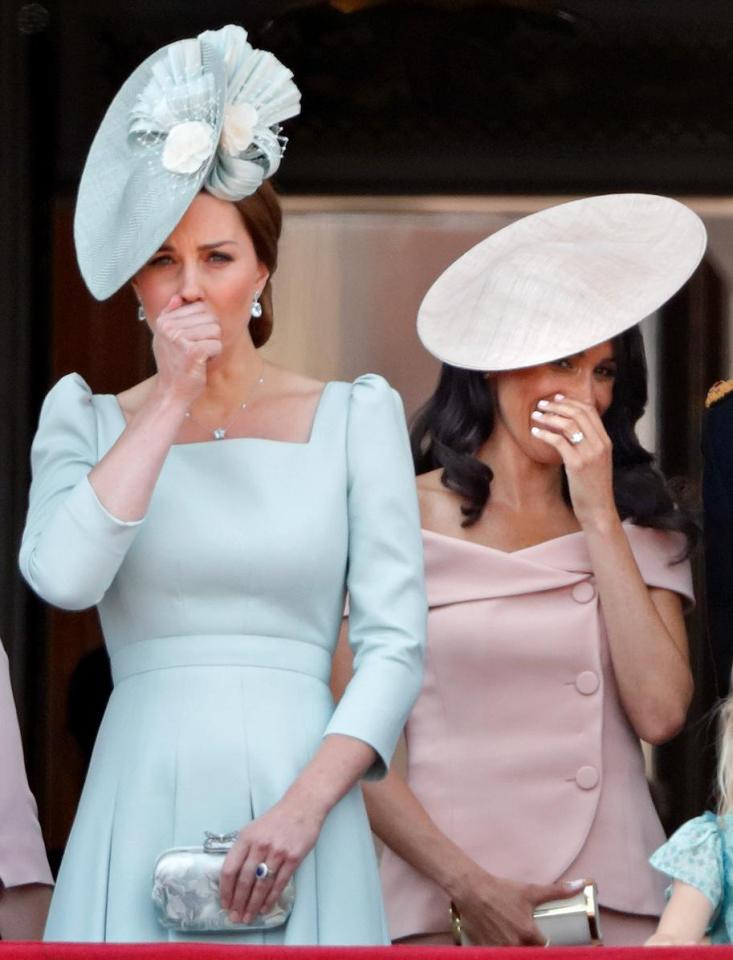  Meghan covers her mouth, suggesting she's hiding a naughty smile