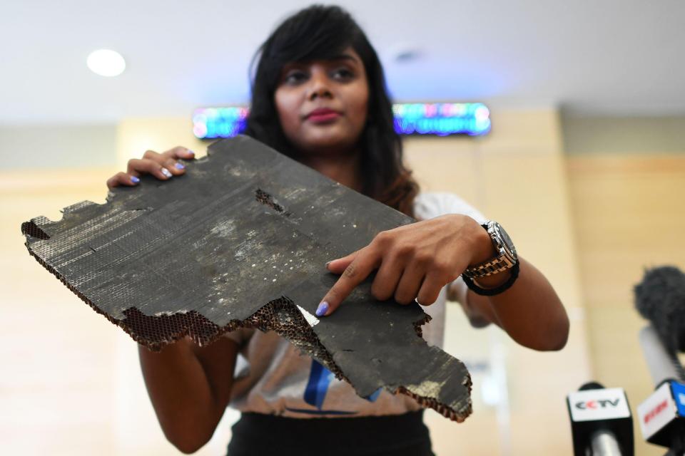  Grace Subathirai Nathan, daughter of passenger Anne Daisy, shows a piece of debris believed to be from flight MH370