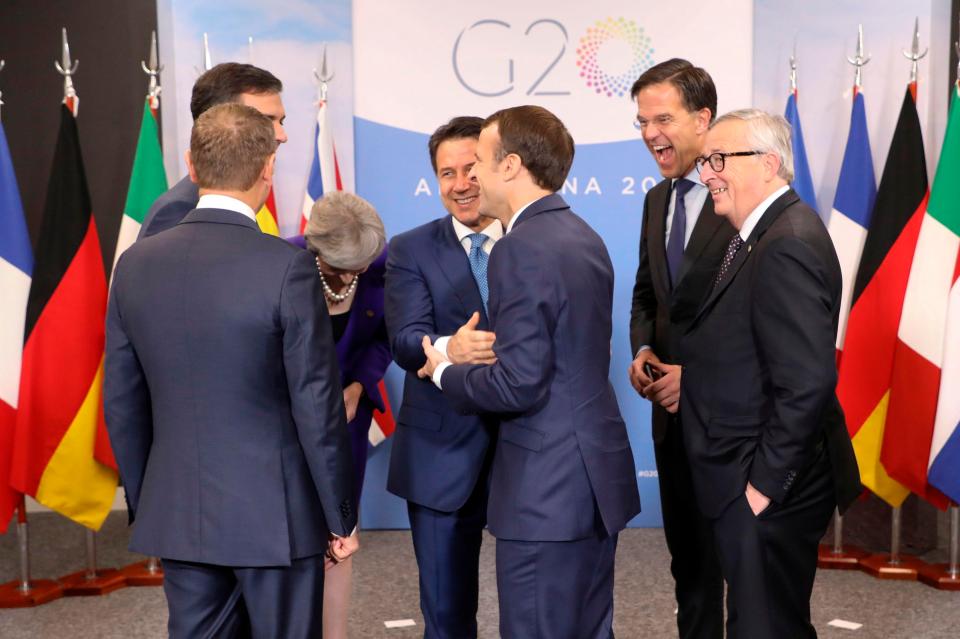  The leaders shared a joke as they had a family photo together, with Mrs May doubled up laughing at one point