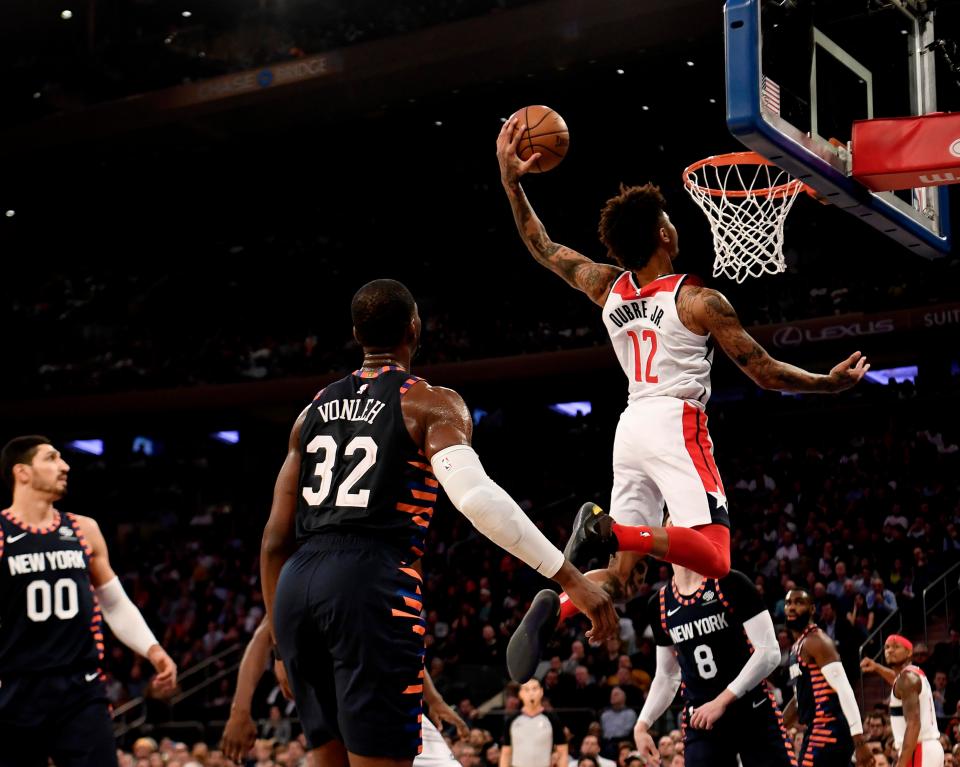  Kelly Oubre Jr slams in a dunk in Washington's win against New York on Monday