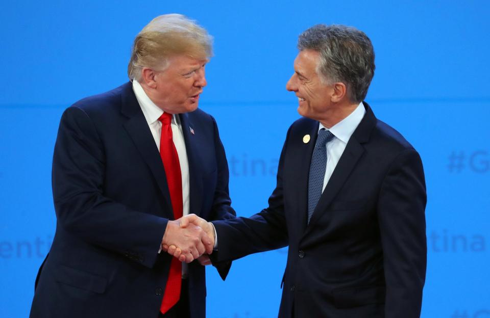  Trump was pictured shaking hands with Macri - before walking off