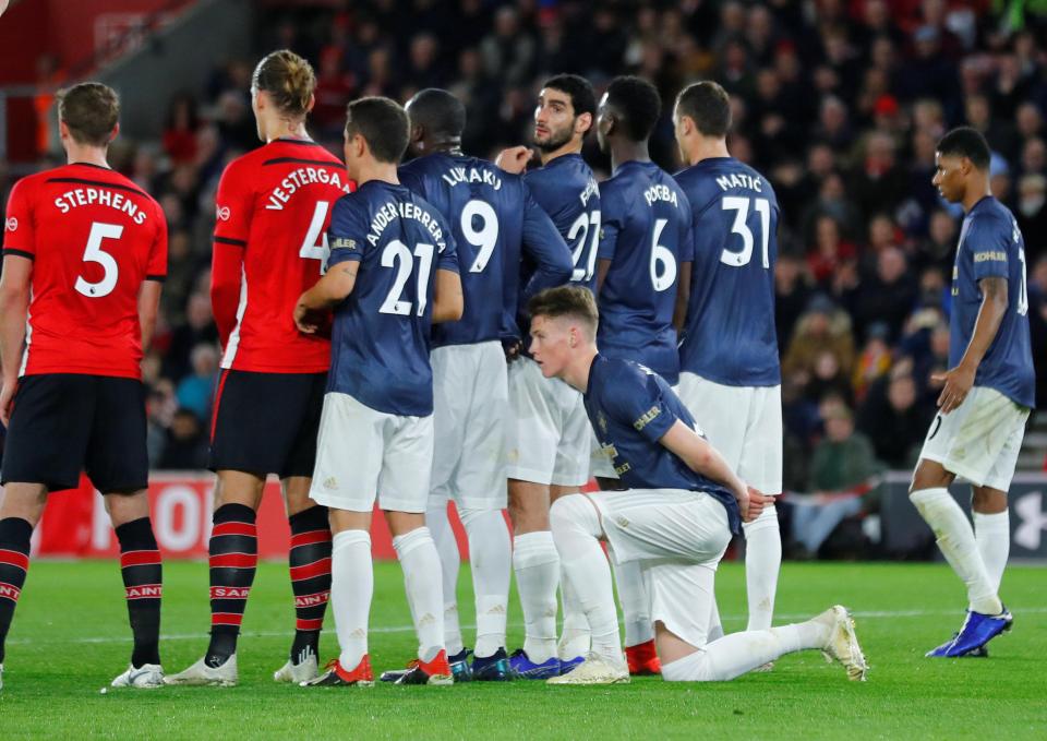  Scottish international Scott McTominay bizarrely knelt behind the wall for Cedric's fine goal