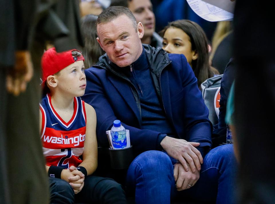  Wayne Rooney with his son Kai watching an NBA game in Washington