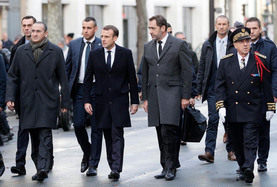  President Macron, flanked by ministers and police chiefs, surveys the scenes of destruction in Paris