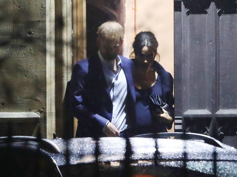 The Duchess of Sussex shows her baby bump as her and Prince Harry attend the carol charity service