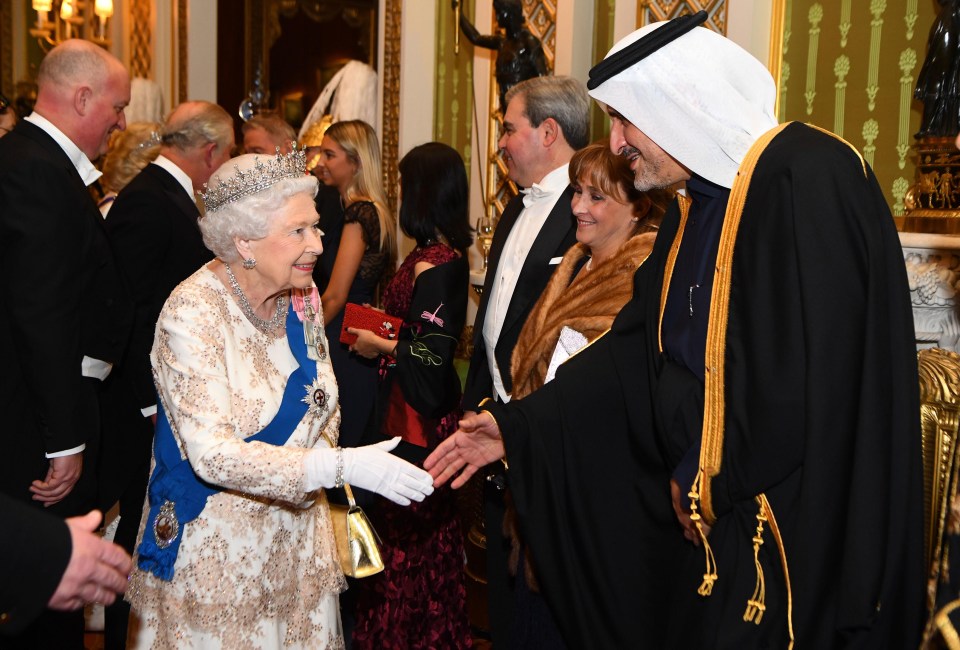 The Queen greets the ambassador of Qatar at an evening reception at Buckingham Palace