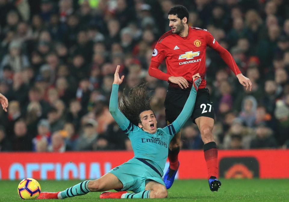  Geundouzi fumes at the way Fellaini had pulled on his hair to stop his run