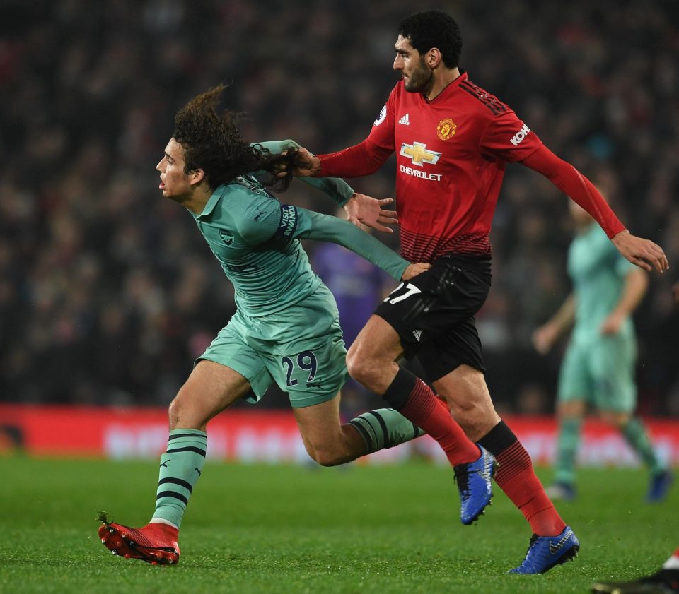  Fellaini took a firm grip on the flowing locks of the Arsenal teenager