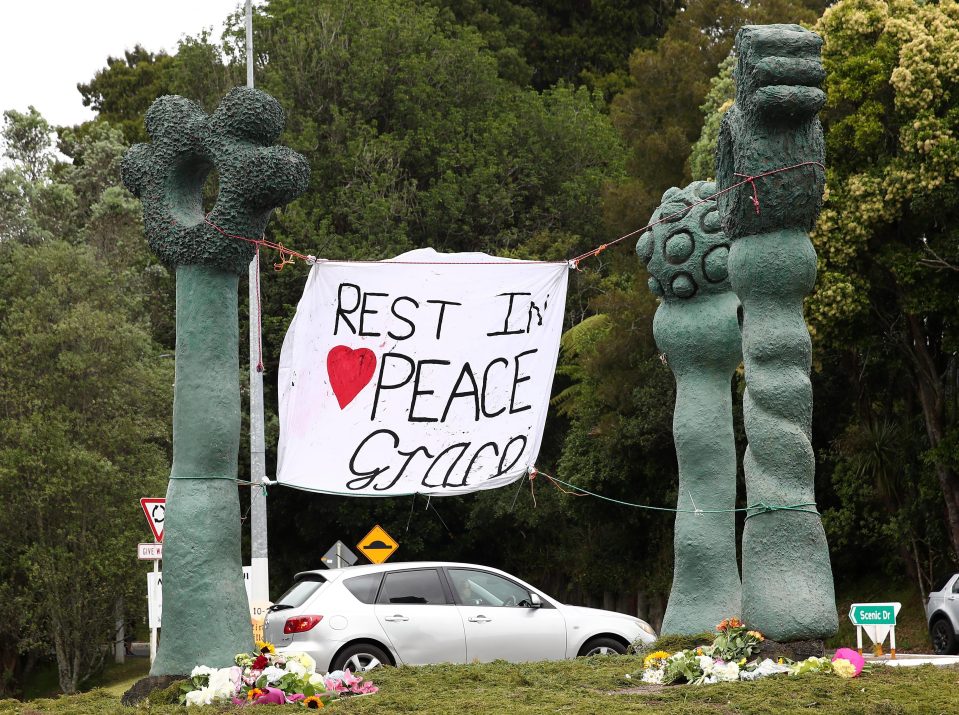  Tributes to Grace Millane are left at a roundabout in Titirangi