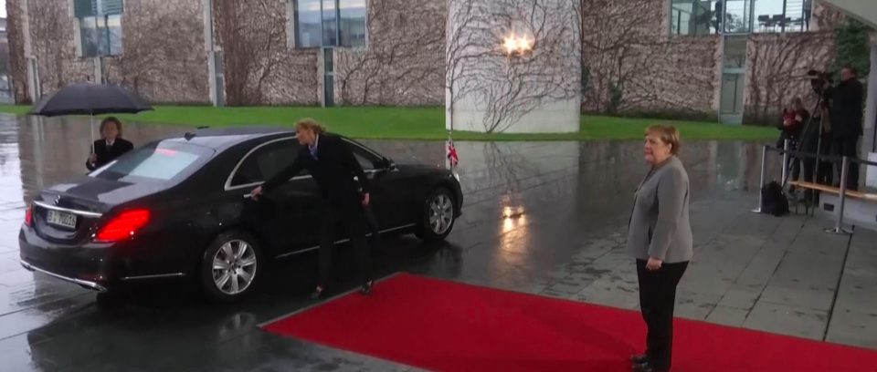  This is the awkward moment Angela Merkel has to wait while Theresa May gets locked in her car