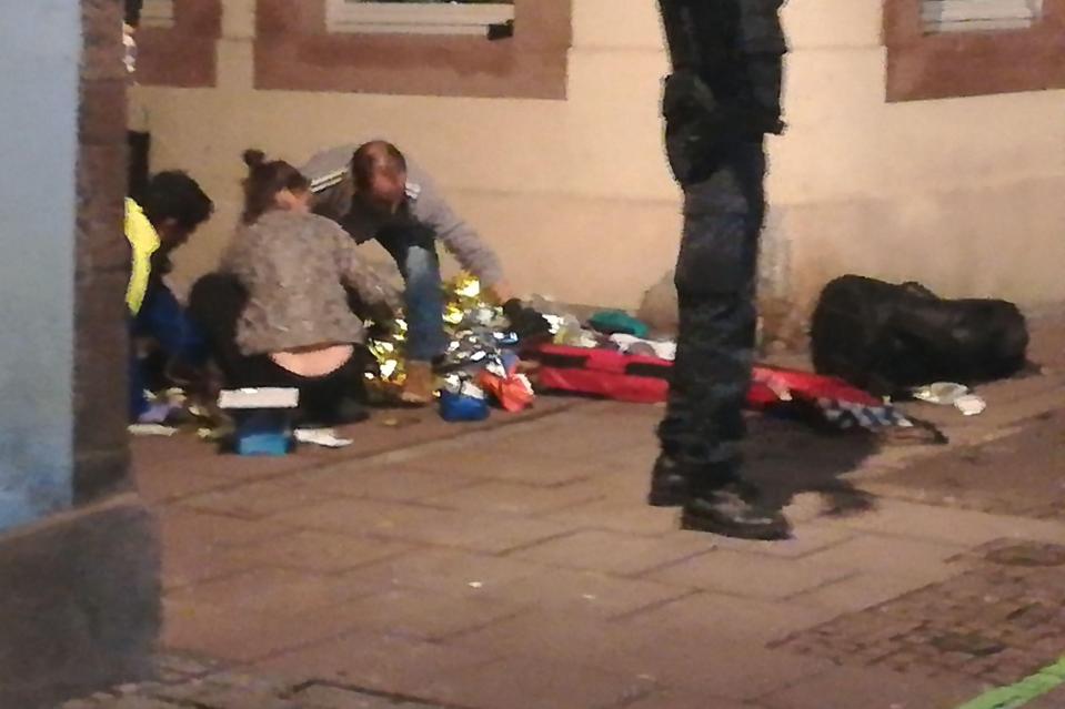  Rescuers treating an injured person in the streets of Strasbourg