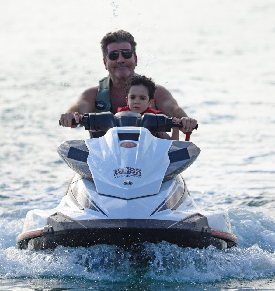 Eric looked slightly unsure as the father and son bounced around the waves