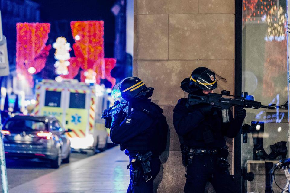  Armed police stand guard after the shooting