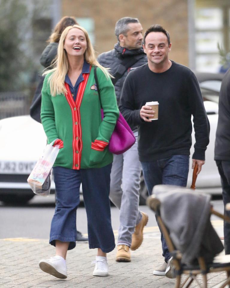  The couple grinned as they strolled through a busy street in West London