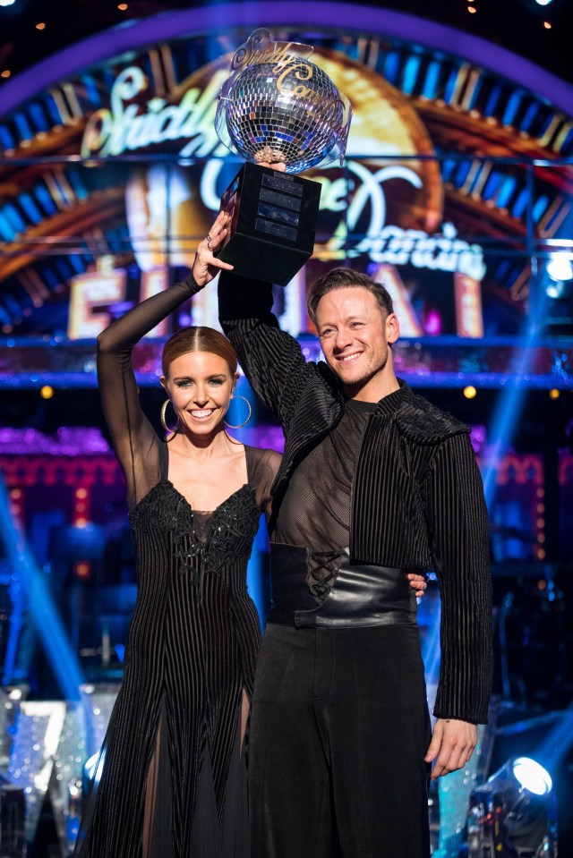 Stacey and Kevin lift their trophy