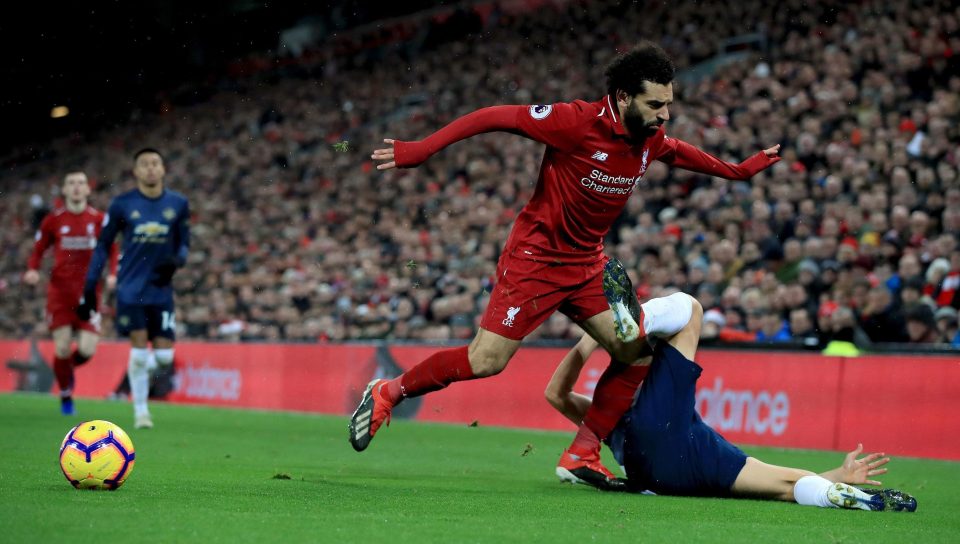  Mohamed Salah tumbles over the challenge of United midfielder Ander Herrera