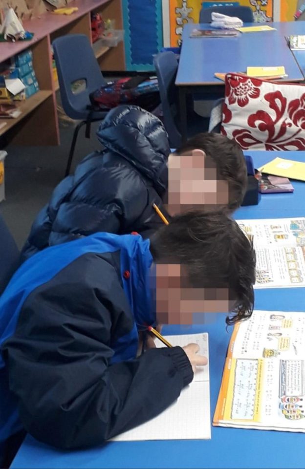  Kids were spotted wearing heavy winter coats as they work in the freezing classroom