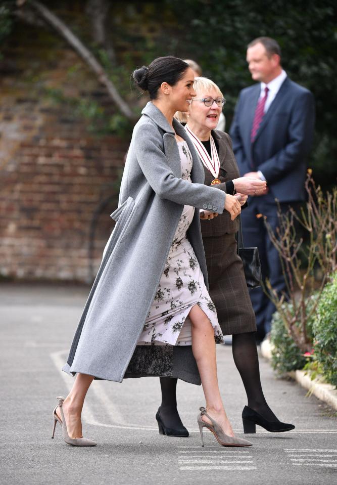  The Duchess of Sussex wore a long grey coat over her dress