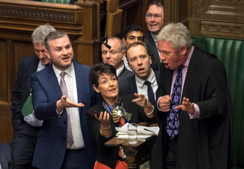  MPs grouped around Speaker John Bercow's chair trying to show him the video of the insult