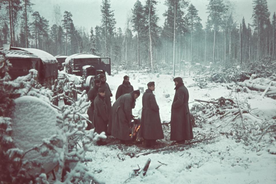  Soldiers warm up around a fire in the snowy town