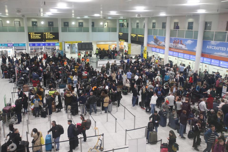  Passengers queue up at airline gates in Gatwick airport today as a small number of flights depart