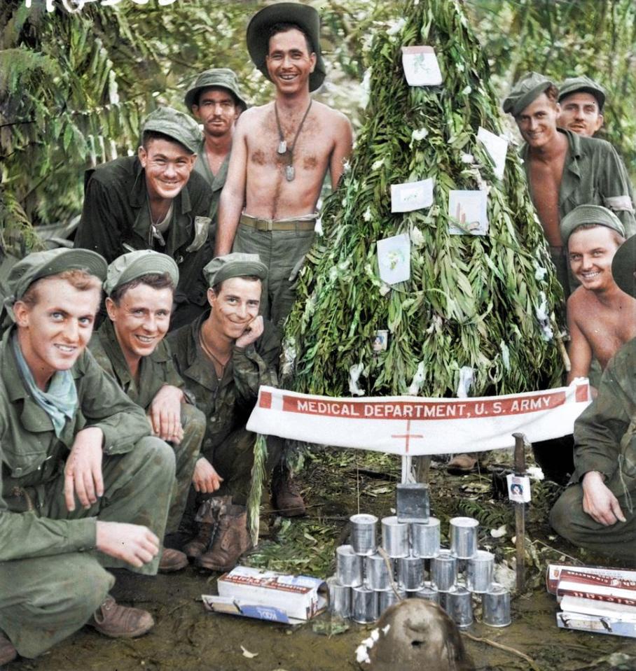  American soldiers in Papau New Guinea with their homemade Christmas tree that is decorated with surgical cotton wool and cigarette cartons in 1942