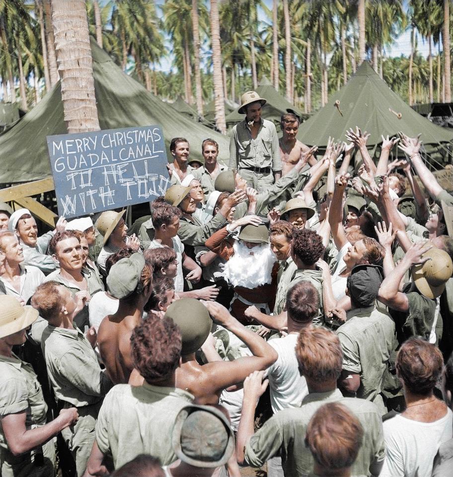  A rowdy group of American soldiers surrounding Santa Claus arriving to Guadalcanal in the Solomon Islands