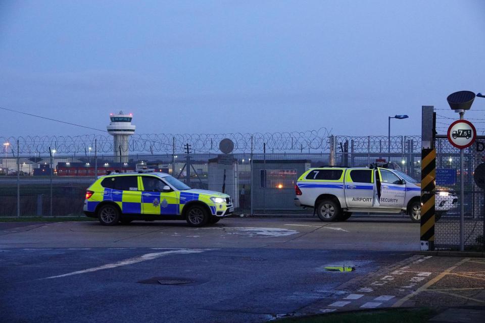  Police cars outside Gatwick Airport after 140,000 passengers were caught up in drone chaos