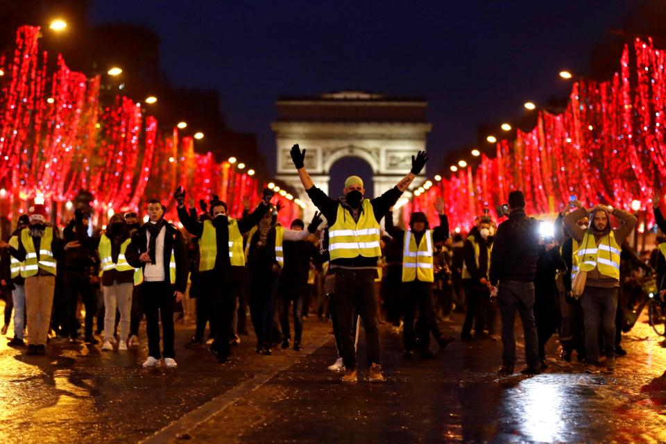  Yellow vest protesters on the Champs Elysees near the Arc de Triomphe in Paris, France