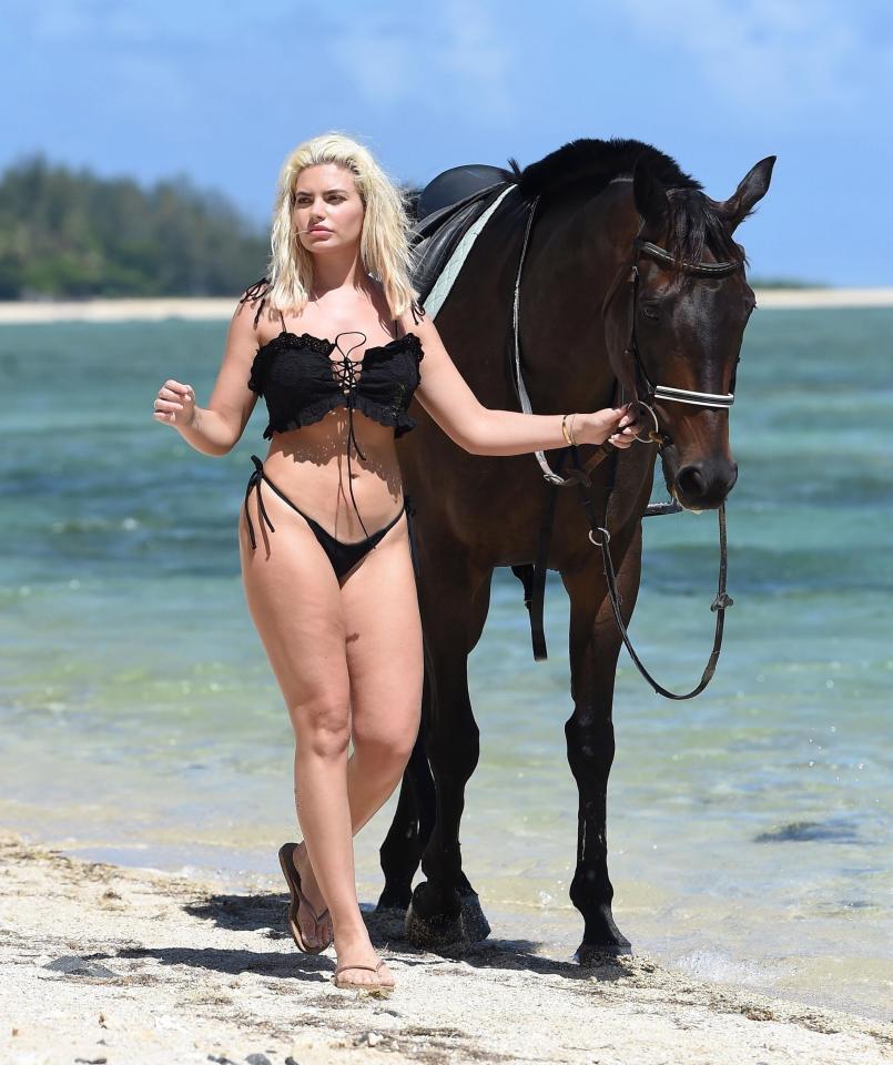  Megan looked confident as she walked down the beach in a tiny thong bikini