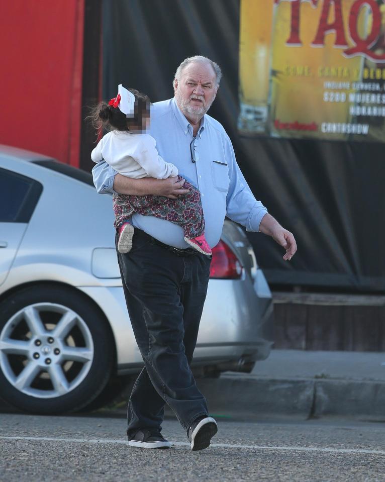  The 74-year-old was seen carrying a tot as he helped with the festive fun