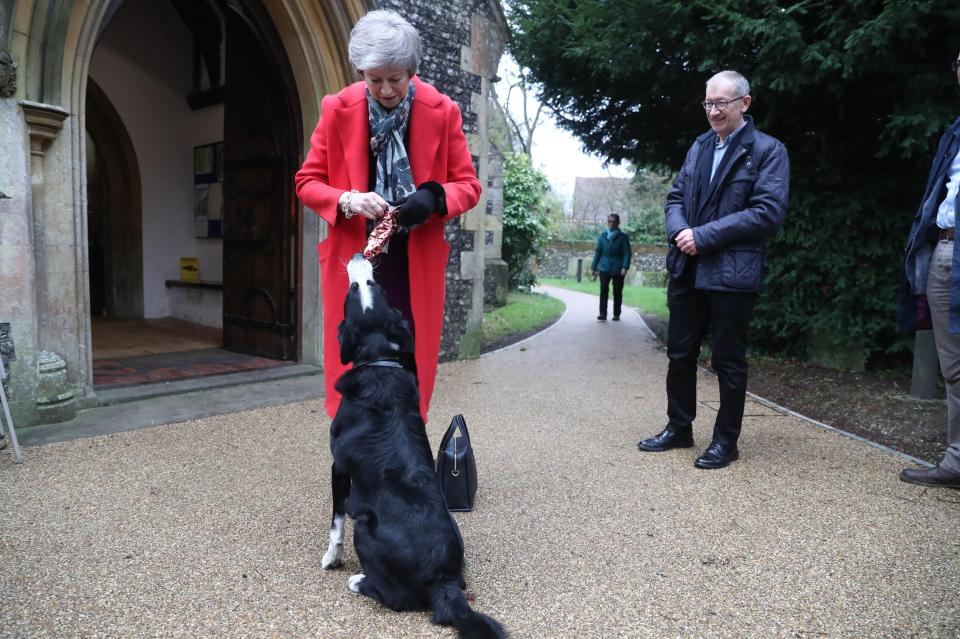  Theresa May was ambushed by a playful dog at a church service in Berkshire today