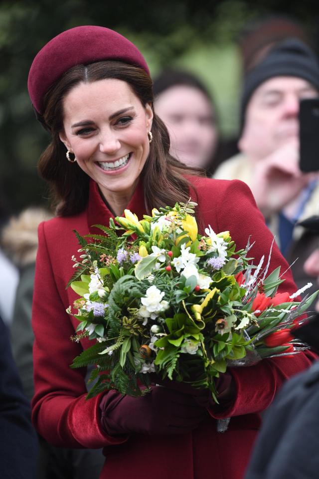  Kate beamed as she was handed flowers by the crowds