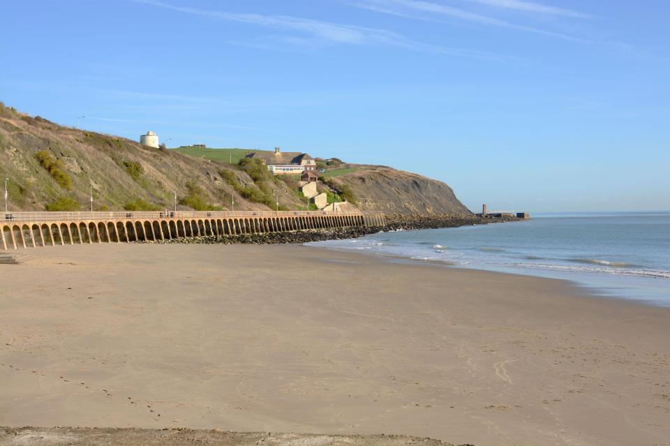  Lee Buzzle said he saw a group of eight migrants huddled around a fire on a beach in Folkestone, pictured, at 3am