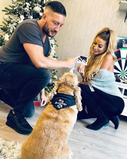 Mrs Hinch and her husband pose with Henry the dog to share the news