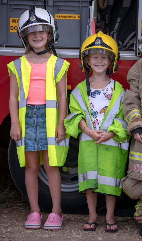  Savannah and Isla also appeared to have plenty of fun trying on firefighters' clothing on the second day of the Festival of British Eventing at Gatcombe Park