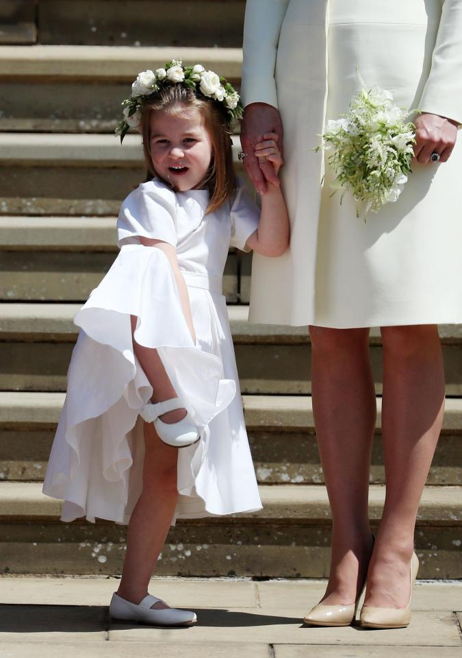  She was also snapped fidgeting next to her mum Kate Middleton on the same day