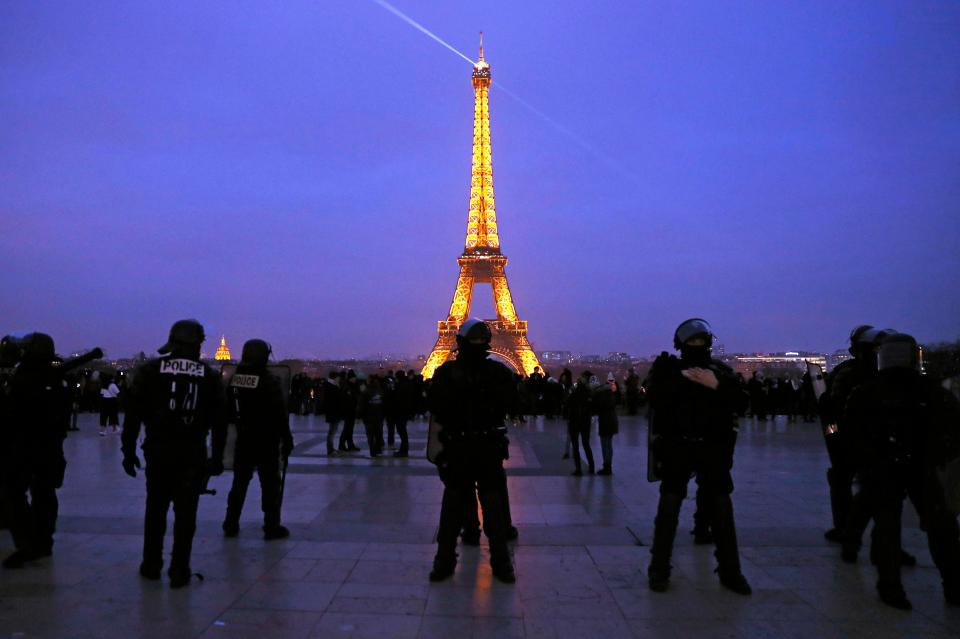  French riot police stand guard in front of the Eiffel Tower