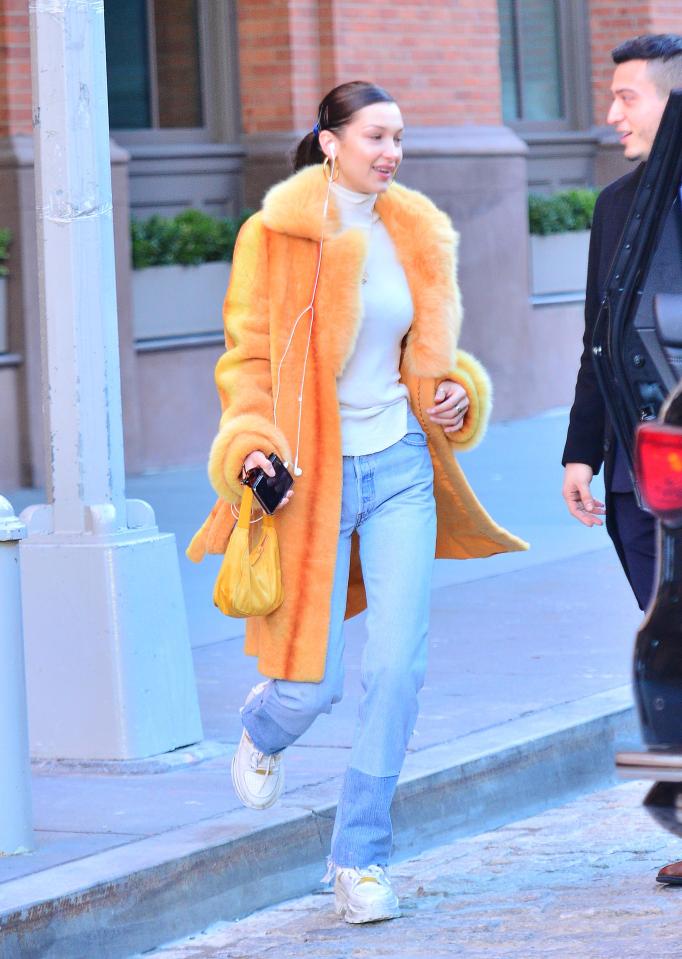  Bella Hadid joins sister Gigi for a shopping trip in New York wearing an orange fur coat