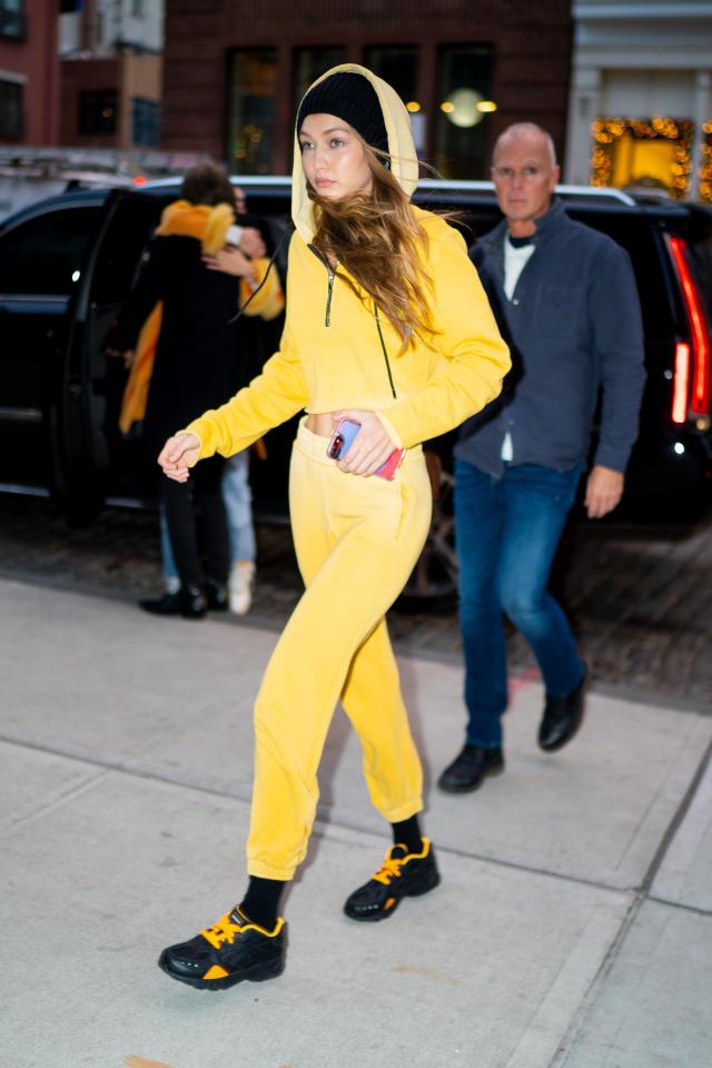  Model Gigi Hadid heads to a toy store wearing a bright yellow tracksuit