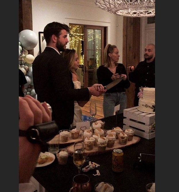  This photo of the couple cutting a wedding cake tipped fans off that they had wed