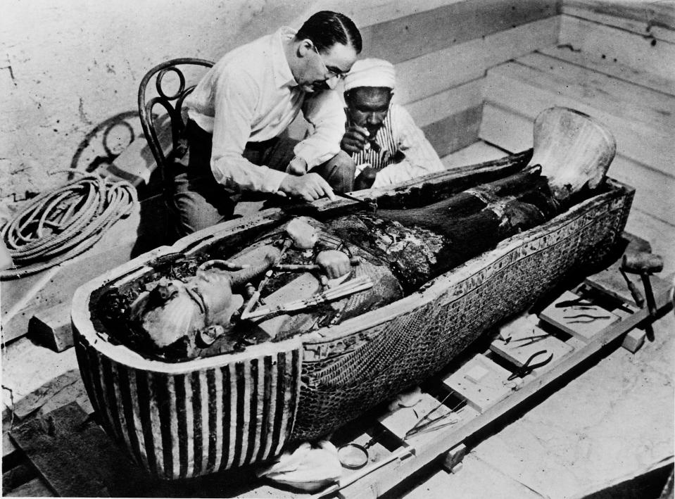  Archaeologist Howard Carter removing oils from the coffin of Tutankhamun