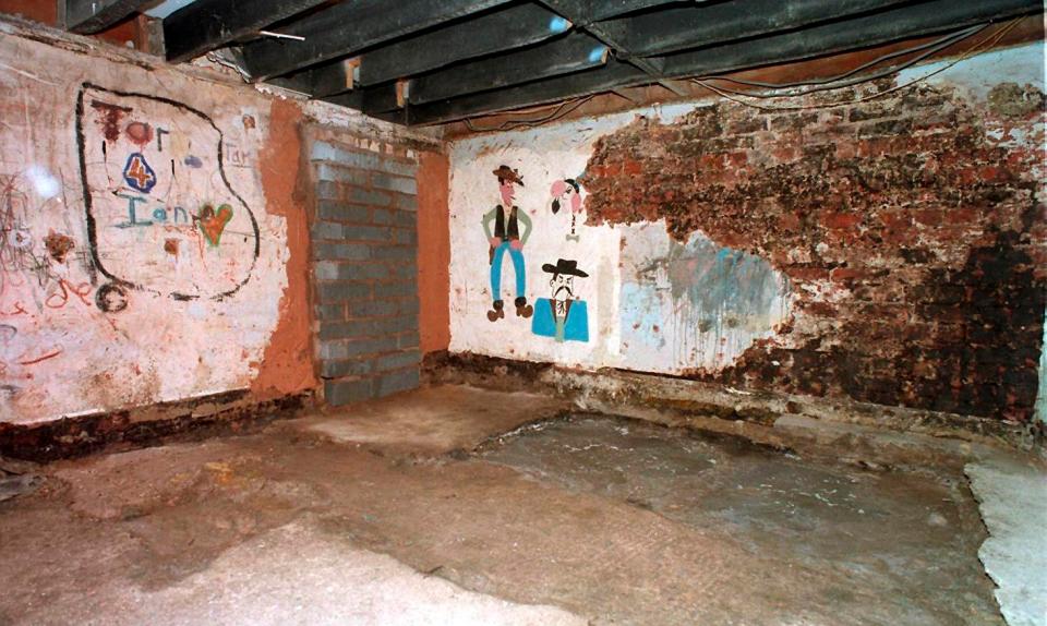  The children were forced to sleep in the basement where five decapitated bodies were later exhumed