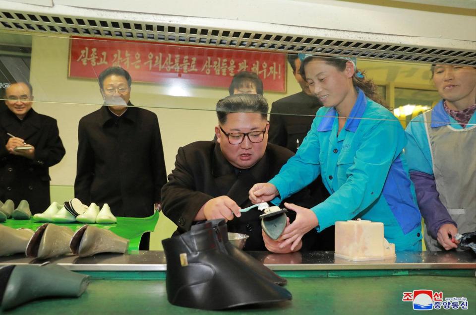  Kim is shown how the shoes are made during a visit