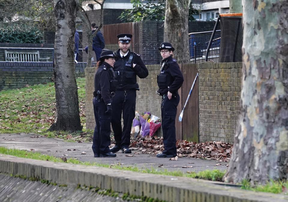  Cops stand guard outside the address where a woman was stabbed on New Year's Day