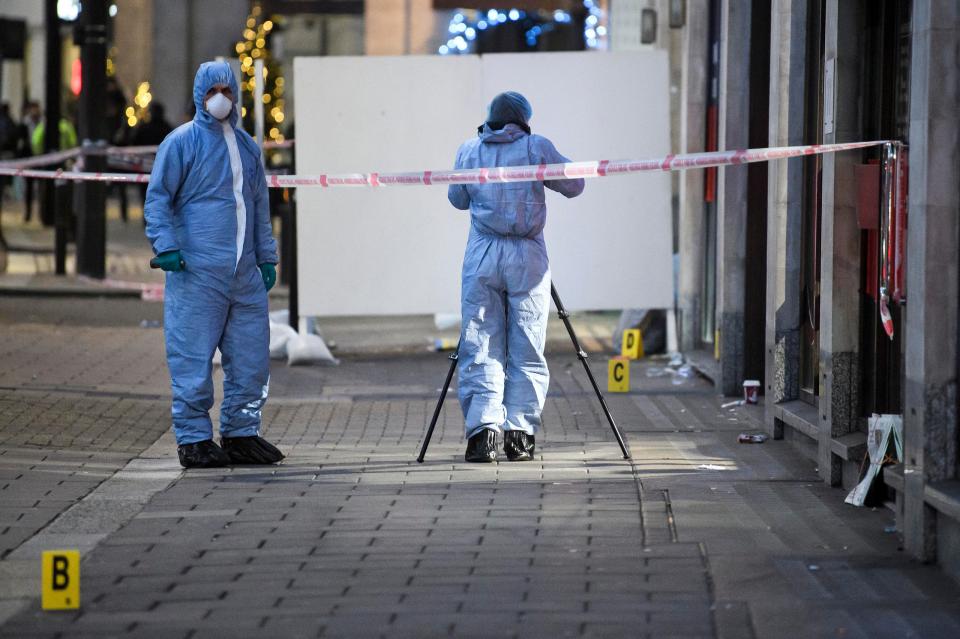  Forensics officers work at the scene of Tudor Simionov's murder