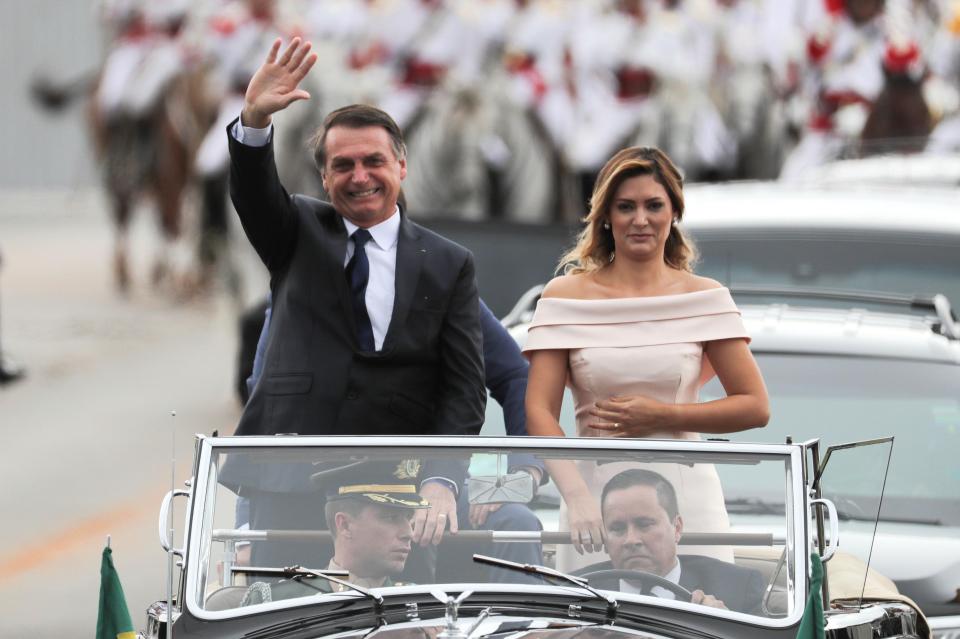  Bolsonaro waved to the crowd as he made his way to the presidential palace in an open-top Rolls-Royce, alongside his wife Michelle