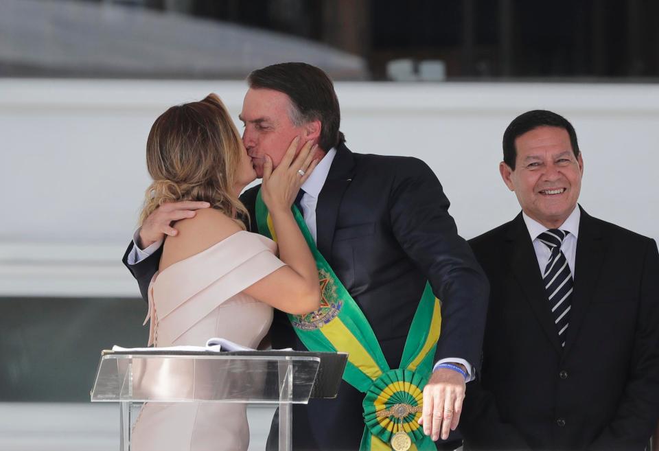  Bolsonaro kisses his wife Michelle after being sworn in