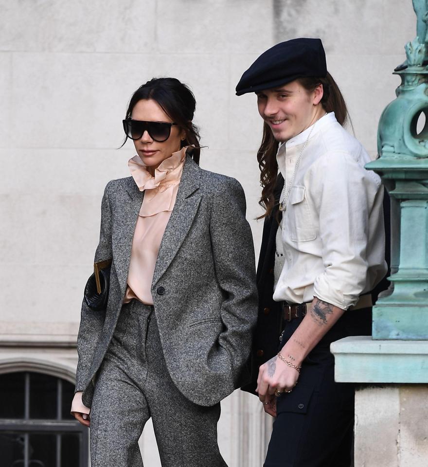  Victoria wore her trademark shades along with a oversized grey suit