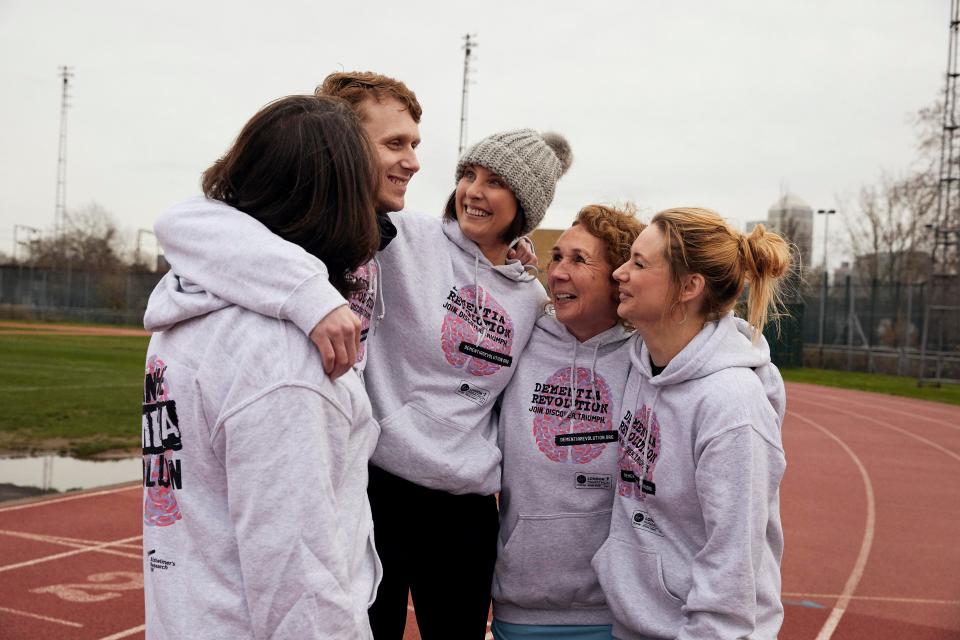  Actress Emma Barton, pictured here in the hat, was in great spirits as they had a team hug before starting training